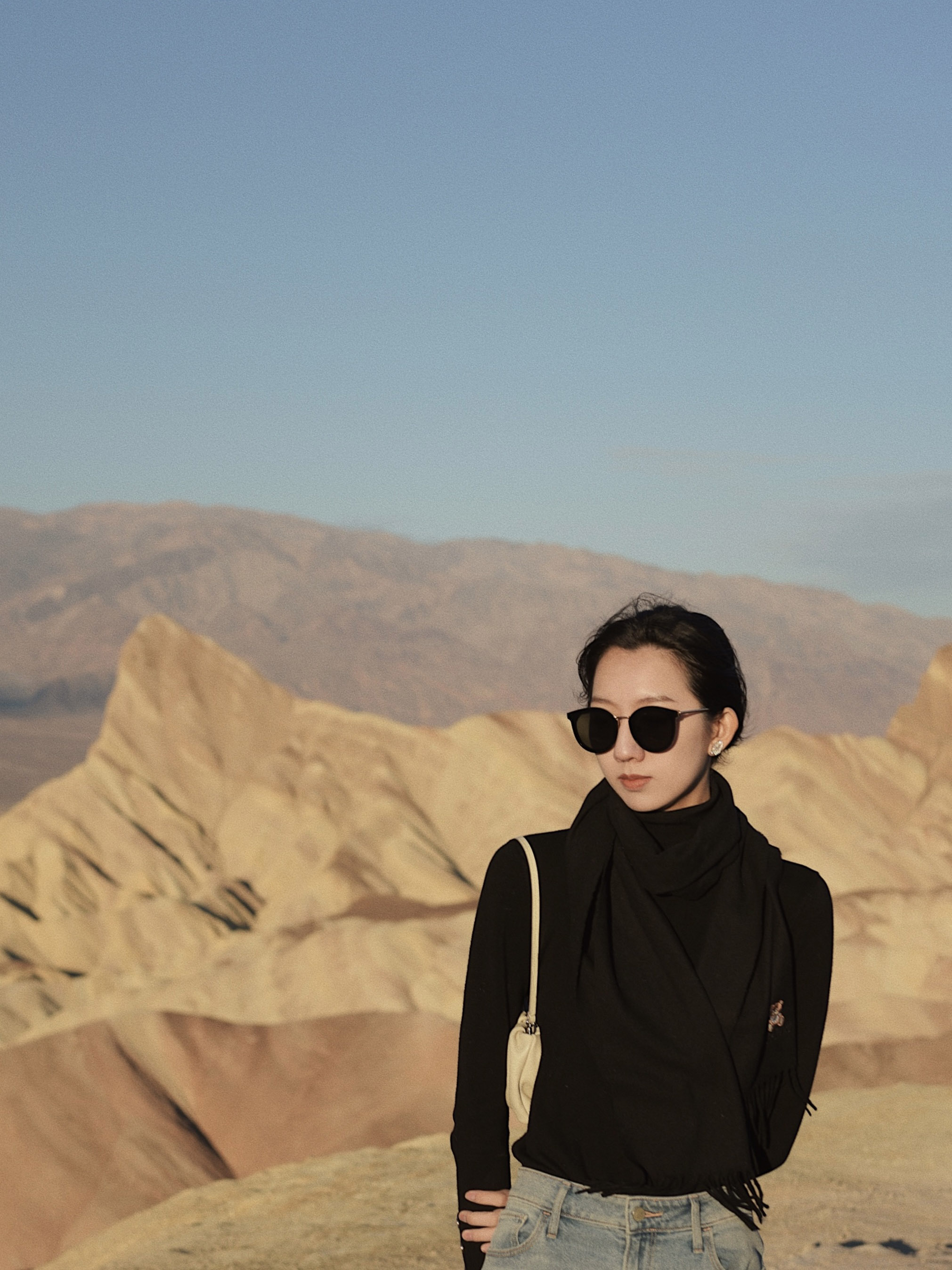 The girl standing in front of the zabriskie Point.